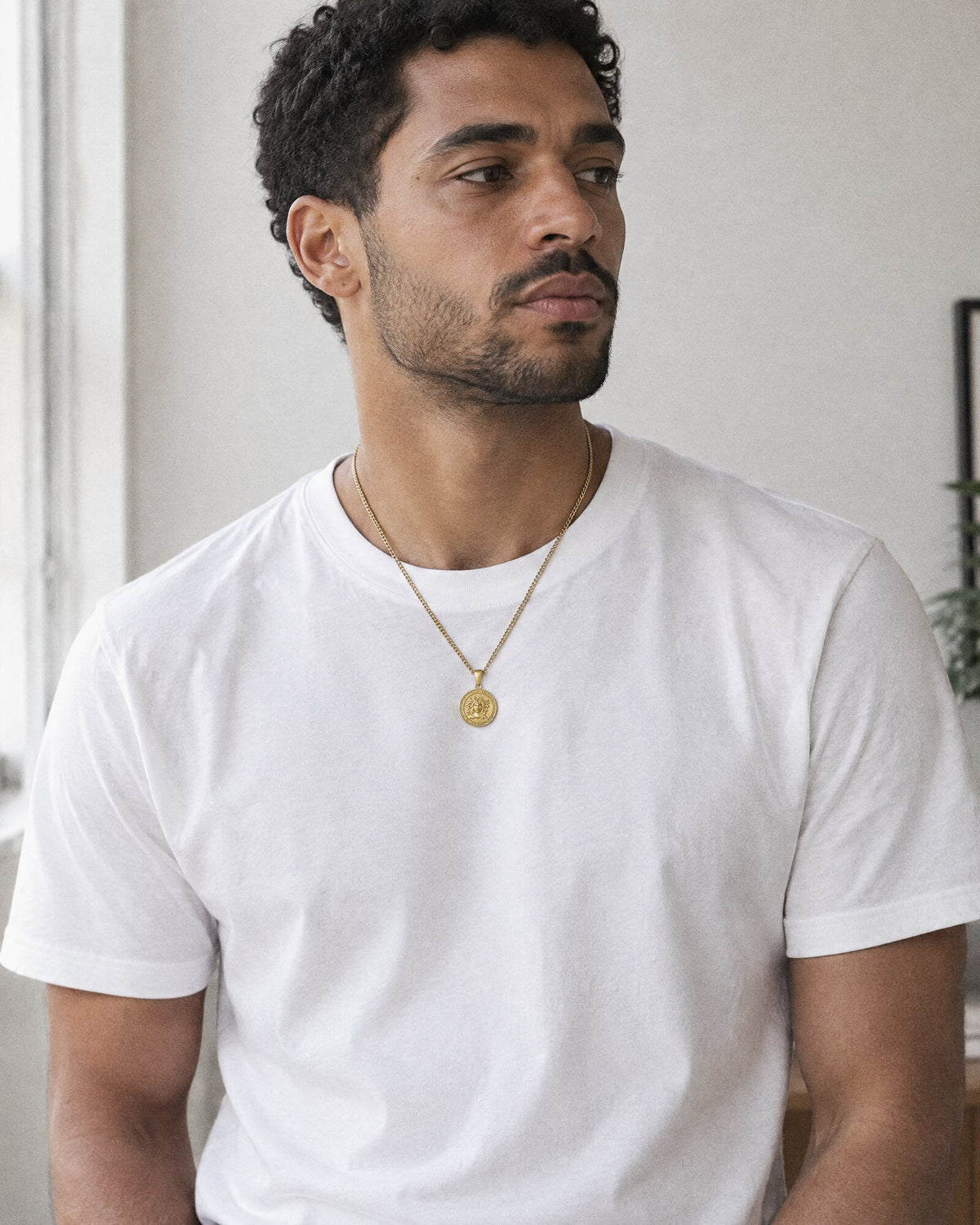 Man wearing the Medusa (Gold) pendant