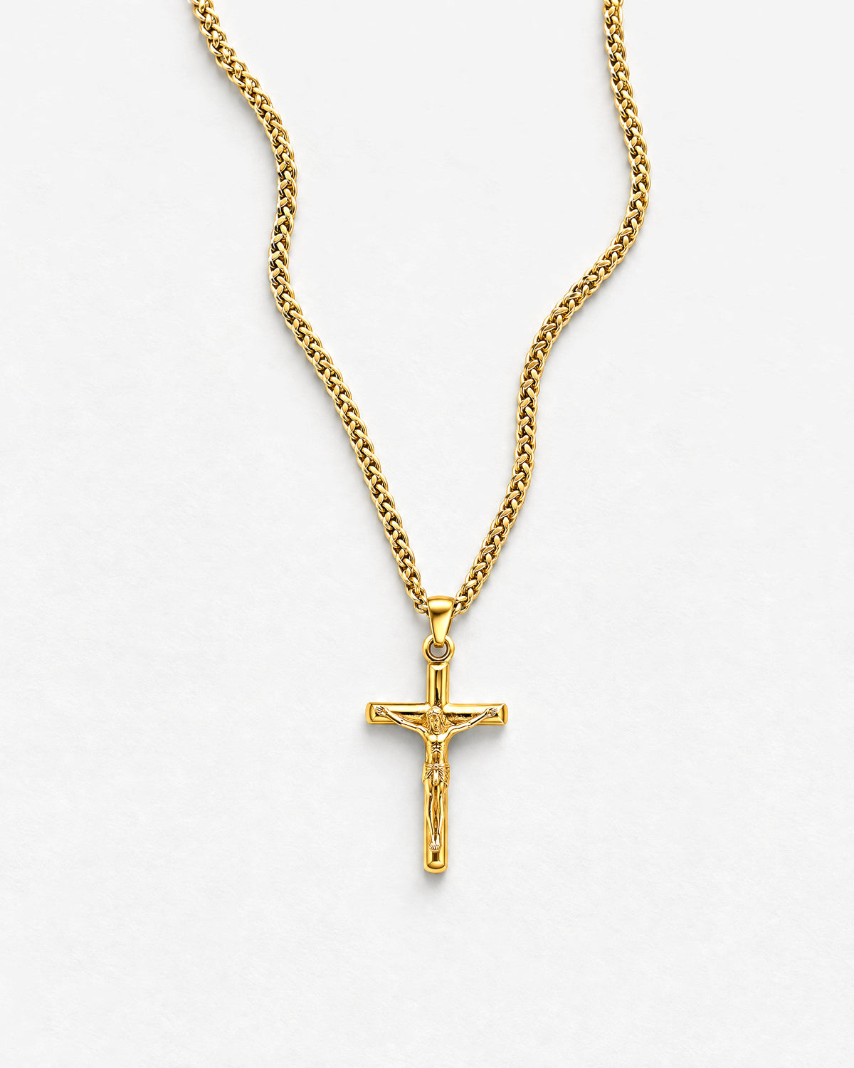 Jesus Cross (Gold) pendant laid flat, close up