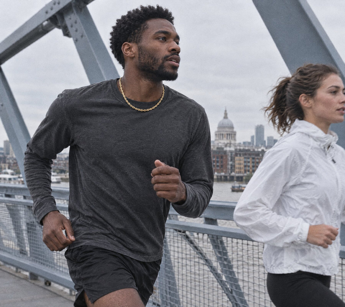 Runners crossing a bridge over the Thames